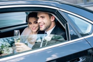 attractive bride and handsome bridegroom holding champagne glass
